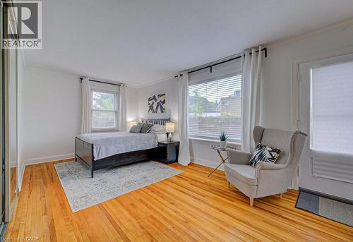 Bright room featuring wood-finish flooring, white walls, and crown molding - 128 Pollock Avenue, Cambridge, ON - Indoor Photo Showing Bedroom