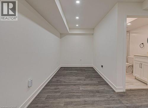 Room featuring wood-finish flooring, recessed lighting, and white baseboards - 128 Pollock Avenue, Cambridge, ON - Indoor Photo Showing Other Room