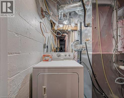 Utility space featuring a dryer appliance, painted cinder block walls, and exposed ductwork - 128 Pollock Avenue, Cambridge, ON - Indoor Photo Showing Laundry Room