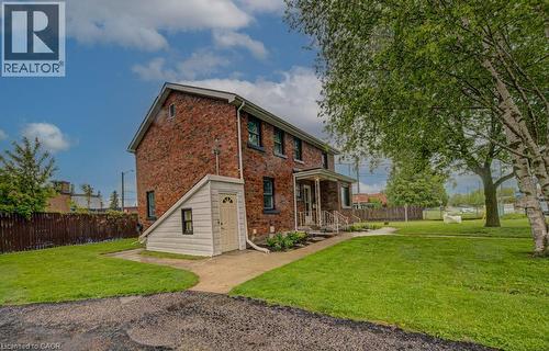 Brick exterior residence with a covered front porch featuring white railings - 128 Pollock Avenue, Cambridge, ON - Outdoor