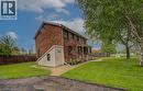 Brick exterior residence with a covered front porch featuring white railings - 128 Pollock Avenue, Cambridge, ON  - Outdoor 