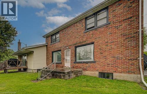 Brick exterior featuring black-framed windows and a lower-level window - 128 Pollock Avenue, Cambridge, ON - Outdoor With Exterior