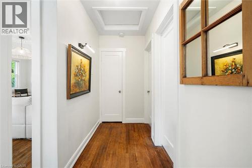 Hallway featuring wood-finish flooring, white trim, recessed ceiling detail, and solid panel doors - 6295 Guelph Line, Burlington, ON - Indoor Photo Showing Other Room