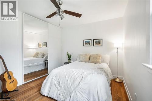 Bedroom featuring wood-finish flooring, white walls, and a ceiling fan with integrated lighting - 6295 Guelph Line, Burlington, ON - Indoor Photo Showing Bedroom