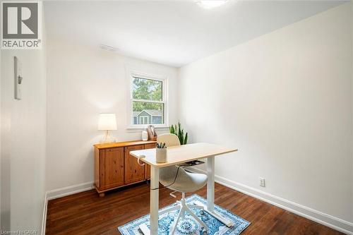 Bright interior space featuring a window with exterior views, hardwood flooring, white baseboards, and a flush-mount ceiling light fixture - 6295 Guelph Line, Burlington, ON - Indoor Photo Showing Office