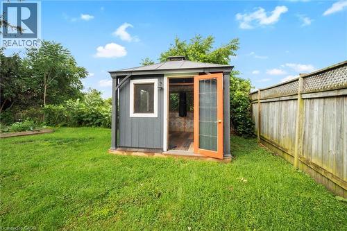 Backyard structure featuring grey siding, a dark roof, and a single window with white trim - 6295 Guelph Line, Burlington, ON - Outdoor
