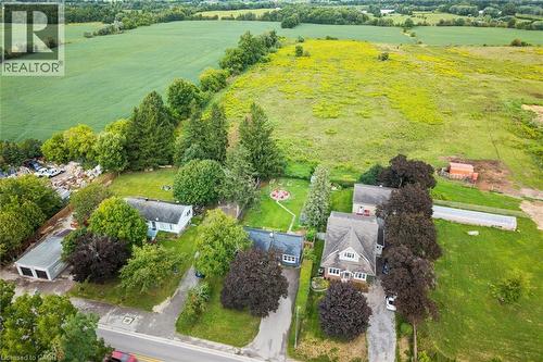 Aerial overview of multiple properties featuring mature tree coverage and expansive green spaces - 6295 Guelph Line, Burlington, ON - Outdoor With View