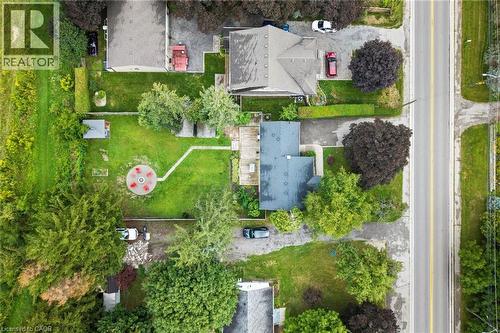 Expansive rear yard featuring a circular patio, a storage shed, and mature trees - 6295 Guelph Line, Burlington, ON - Outdoor With View