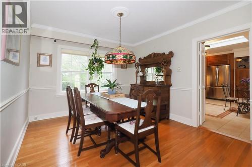 Dining area featuring wood-finish flooring, crown molding, and a window providing natural light - 2023 Coronation Boulevard, Cambridge, ON - Indoor Photo Showing Dining Room