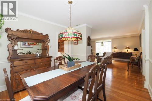 Spacious dining area featuring hardwood flooring, crown molding, and a decorative stained-glass pendant light - 2023 Coronation Boulevard, Cambridge, ON - Indoor Photo Showing Dining Room