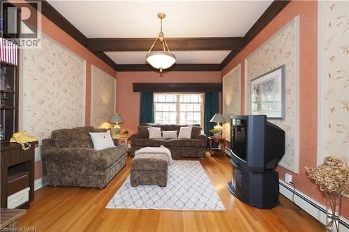 Living area featuring wood-finish flooring, exposed ceiling beams, and a window with natural light - 2023 Coronation Boulevard, Cambridge, ON - Indoor Photo Showing Living Room