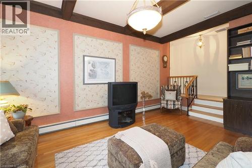 Hardwood flooring extends throughout this room, featuring exposed ceiling beams and a built-in shelving unit - 2023 Coronation Boulevard, Cambridge, ON - Indoor Photo Showing Other Room