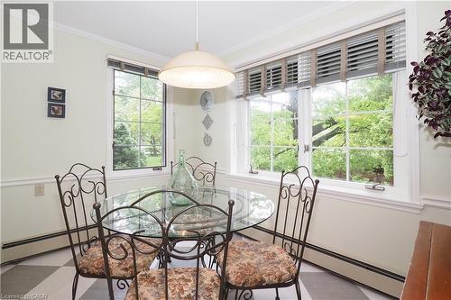 Dining area featuring multiple casement windows, a pendant light fixture, and crown molding - 2023 Coronation Boulevard, Cambridge, ON - Indoor Photo Showing Other Room