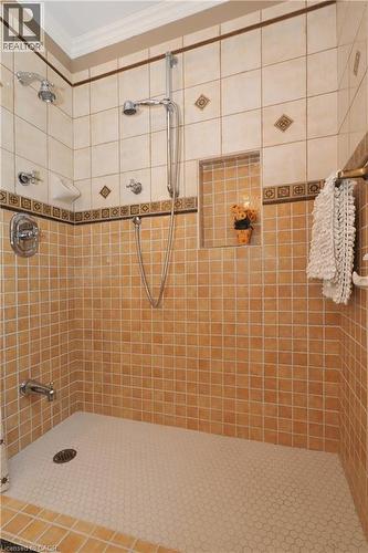 Tiled shower enclosure featuring a mosaic floor, built-in niche, and dual shower heads - 2023 Coronation Boulevard, Cambridge, ON - Indoor Photo Showing Bathroom