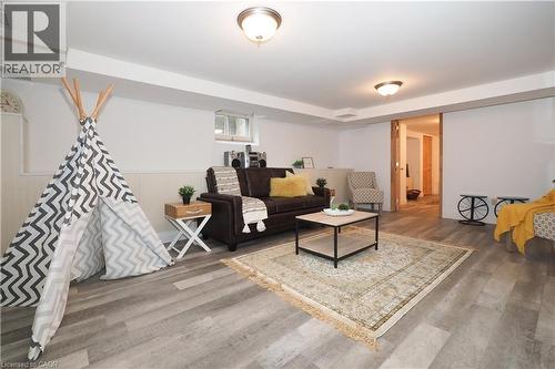 Spacious finished room featuring wood-finish flooring, recessed lighting, white paneled accent wall, and a wood-framed doorway - 2023 Coronation Boulevard, Cambridge, ON - Indoor