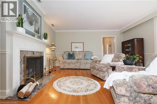 Bright living space featuring hardwood flooring and light-toned walls - 2023 Coronation Boulevard, Cambridge, ON - Indoor Photo Showing Living Room With Fireplace