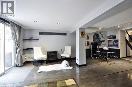Lower level space featuring wood-finish flooring, recessed lighting, and sliding glass door access - 12 Karalee Crescent, Cambridge, ON - Indoor