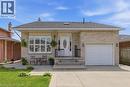 Light brick exterior featuring a covered entry, an integrated garage, a paved driveway, and a front patio area - 27 Barbara Court, Hamilton, ON  - Outdoor 