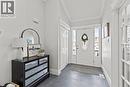 Entryway featuring slate-look floor tile, a white entry door with an oval leaded glass insert, and two vertical sidelight windows - 27 Barbara Court, Hamilton, ON  - Indoor Photo Showing Other Room 
