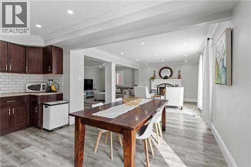 Open-concept living space with wood-finish flooring extending throughout - 27 Barbara Court, Hamilton, ON - Indoor
