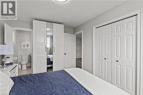 Bedroom featuring light gray wall paint, white trim, and a white six-panel bi-fold closet door - 27 Barbara Court, Hamilton, ON - Indoor Photo Showing Bedroom