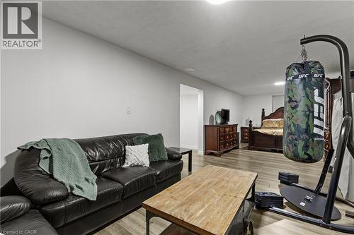 Open-concept room featuring light wood-finish flooring, recessed lighting, and a neutral wall color - 27 Barbara Court, Hamilton, ON - Indoor Photo Showing Living Room