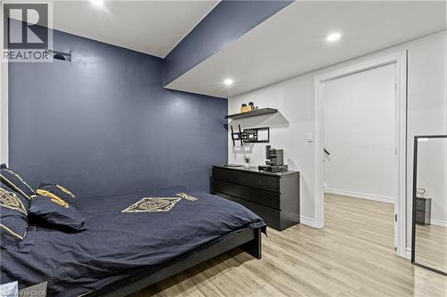 Bedroom featuring a distinct dark accent wall, recessed lighting, and light wood-finish flooring - 27 Barbara Court, Hamilton, ON - Indoor Photo Showing Bedroom