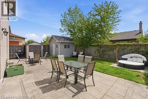 Expansive backyard featuring a large stone patio, manicured lawn, and mature trees - 27 Barbara Court, Hamilton, ON - Outdoor With Deck Patio Veranda