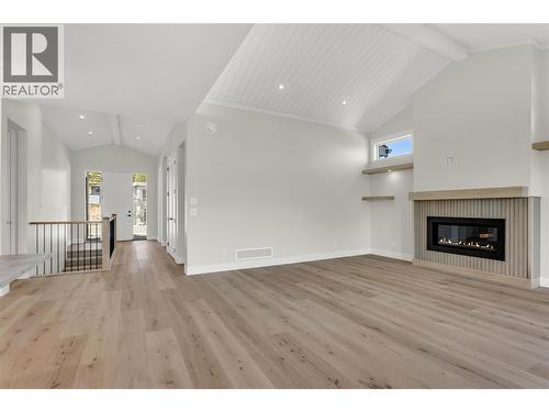 Entry Foyer and Living Room - 2150 Montenegro Drive, Kelowna, BC - Indoor With Fireplace