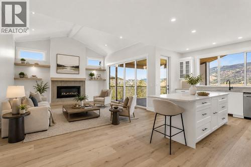Kitchen and Living Room *Virtually Staged* - 2150 Montenegro Drive, Kelowna, BC - Indoor With Fireplace