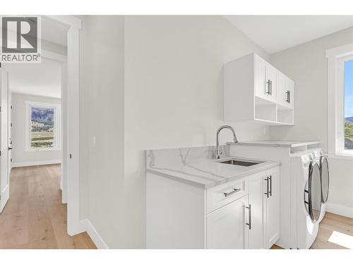 laundry/mud room conveniently located off the garage - 2150 Montenegro Drive, Kelowna, BC - Indoor Photo Showing Laundry Room