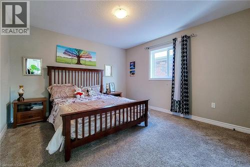Carpeted room featuring a single window, white baseboards, and neutral wall paint - 40 Fairgrounds Drive, Binbrook, ON - Indoor Photo Showing Bedroom