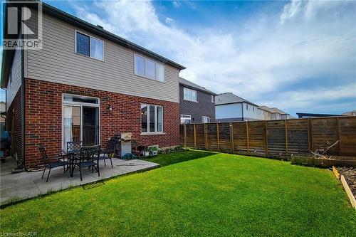 Expansive backyard featuring a manicured lawn, a concrete patio, and a privacy fence - 40 Fairgrounds Drive, Binbrook, ON - Outdoor With Exterior