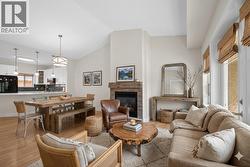 Living/dining room with vaulted ceilings & a gas fireplace **virtually staged** - 