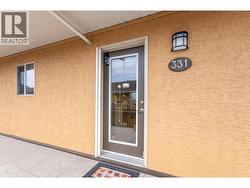 Front door of the unit with exterior hallways throughout the building - 