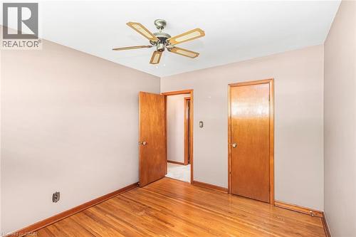 Wood-finish flooring with coordinating wood trim throughout - 435 East 36Th Street, Hamilton, ON - Indoor Photo Showing Other Room