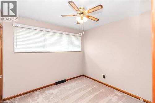 Room featuring neutral-toned carpeting, light-colored walls, and a ceiling fan with integrated lighting - 435 East 36Th Street, Hamilton, ON - Indoor Photo Showing Other Room