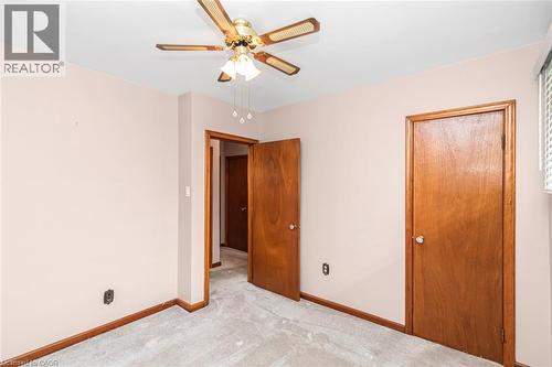 Carpeted room with light pink walls and wood-finish trim - 435 East 36Th Street, Hamilton, ON - Indoor Photo Showing Other Room