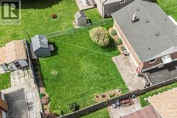 Expansive green lawn with mature landscaping and established trees - 
