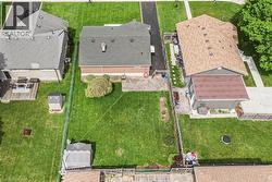 Expansive green lawn with mature landscaping - 