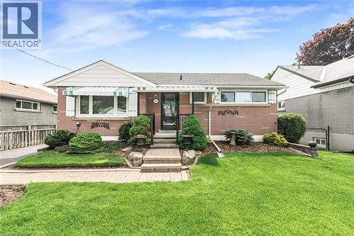 Red brick exterior with white trim and a gabled accent - 435 East 36Th Street, Hamilton, ON - Outdoor