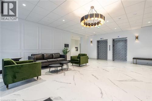 Spacious lobby featuring large format marble-look flooring and wainscoting - 1936 Rymal Road E Unit# 512, Hamilton, ON - Indoor Photo Showing Other Room