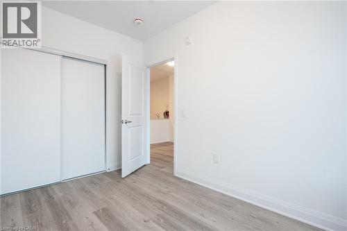 Interior room featuring light wood-finish flooring, white walls, and white trim - 1936 Rymal Road E Unit# 512, Hamilton, ON - Indoor Photo Showing Other Room