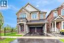 Two-story residence featuring a brick and stone facade, covered front entry, two-car garage with car port, and second-story balcony with iron railing - 3937 Leonardo Street, Burlington, ON  - Outdoor With Facade 