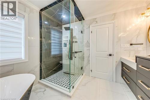 Walk-in glass shower with black hexagon tile flooring and built-in shelving - 3937 Leonardo Street, Burlington, ON - Indoor Photo Showing Bathroom