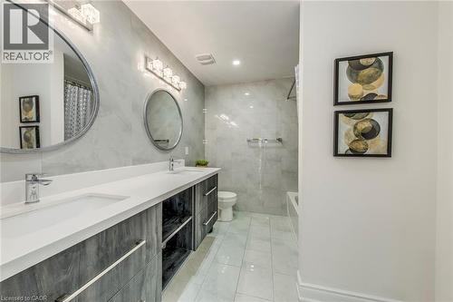 Dual vanity featuring white countertops and wood-finish cabinetry - 3937 Leonardo Street, Burlington, ON - Indoor Photo Showing Bathroom