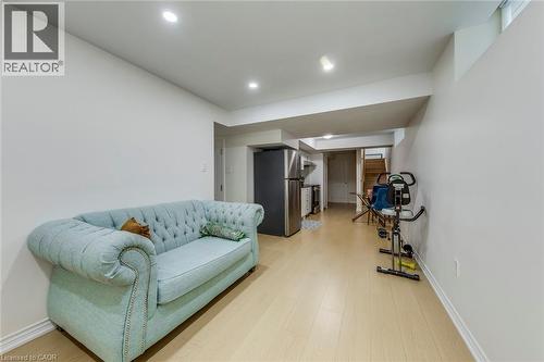 Open-concept lower level featuring recessed lighting, light wood-finish flooring, and white baseboards - 3937 Leonardo Street, Burlington, ON - Indoor