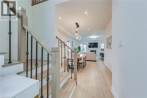 Hardwood flooring extends throughout this luminous entryway and main living area - 3937 Leonardo Street, Burlington, ON - Indoor Photo Showing Other Room