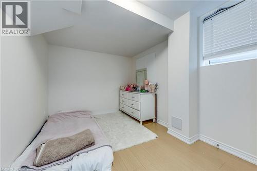 Room featuring light wood-finish flooring, white walls, and a window with white blinds - 3937 Leonardo Street, Burlington, ON - Indoor Photo Showing Bedroom