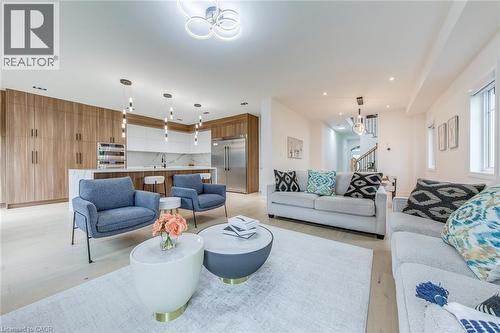 Contemporary open-concept living space featuring light wood-finish flooring, recessed lighting, and a modern kitchen with a large island - 3937 Leonardo Street, Burlington, ON - Indoor Photo Showing Living Room